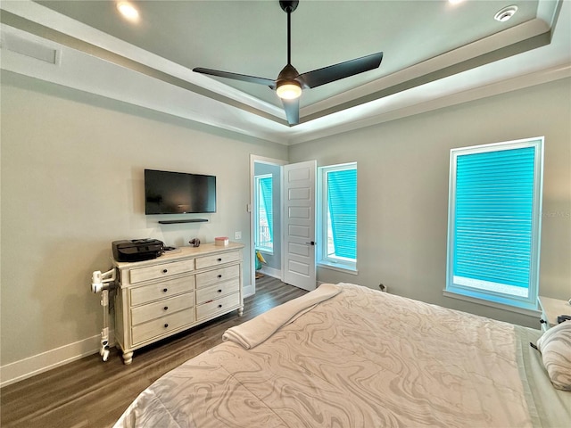 bedroom featuring a tray ceiling, ceiling fan, and dark hardwood / wood-style floors