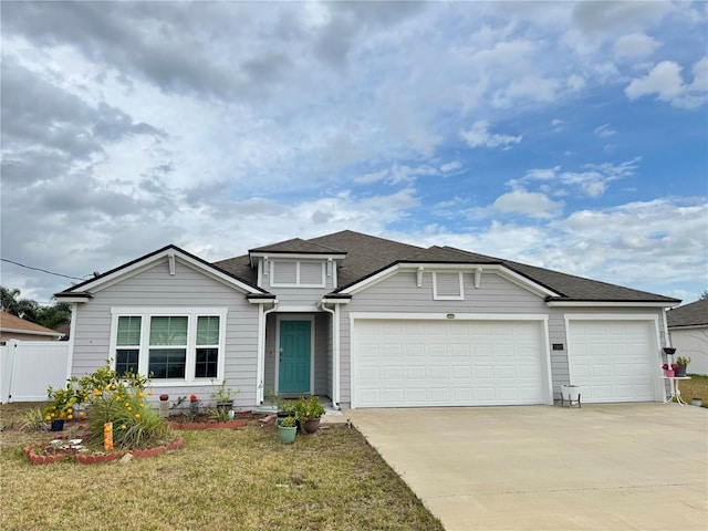 view of front of house with a front lawn and a garage