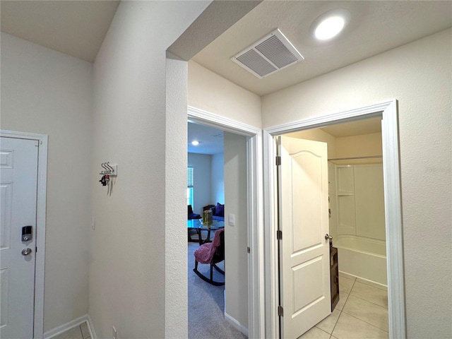 corridor with light tile patterned flooring