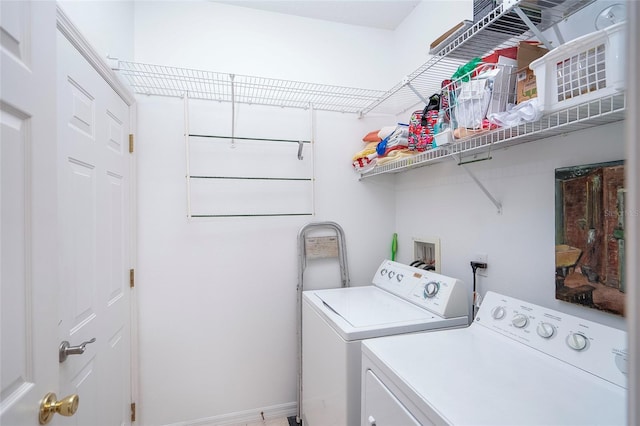 clothes washing area with washing machine and dryer