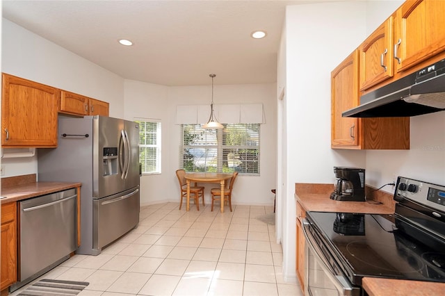 kitchen with stainless steel appliances, hanging light fixtures, and light tile patterned floors