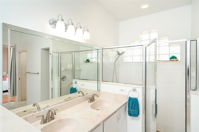 bathroom featuring vanity and a shower with shower door