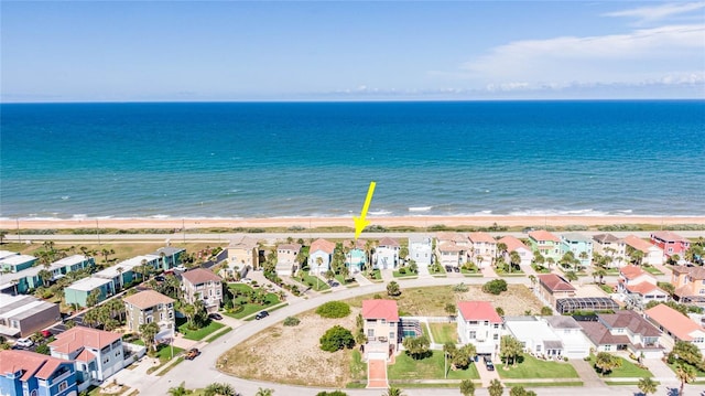 drone / aerial view featuring a water view and a beach view