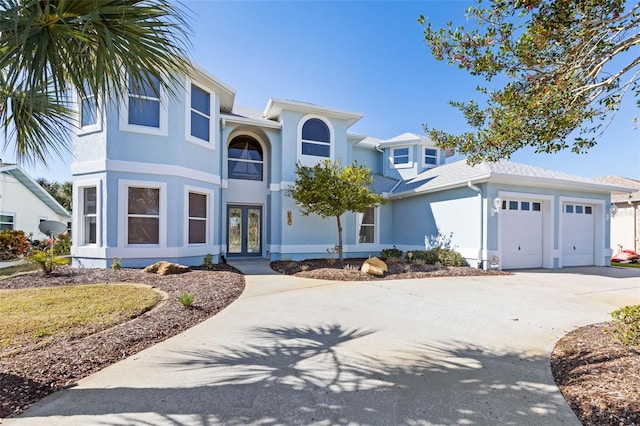 view of front of property with a garage and french doors