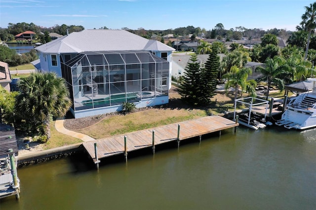 view of dock featuring glass enclosure and a water view