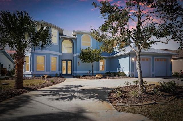 view of front of property with a garage and french doors