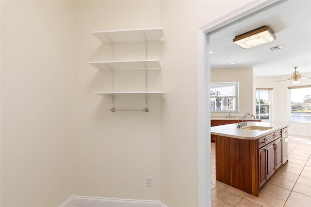 bathroom featuring ceiling fan, sink, and tile patterned floors