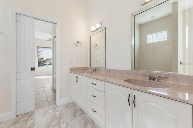 bathroom featuring ceiling fan, a healthy amount of sunlight, tile patterned floors, and vanity