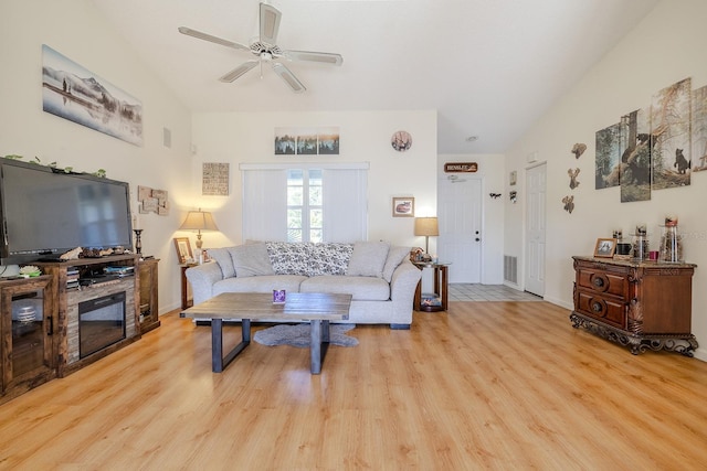 living room featuring light hardwood / wood-style floors and ceiling fan