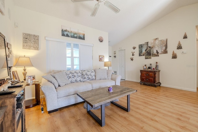 living room with ceiling fan, light hardwood / wood-style floors, and vaulted ceiling