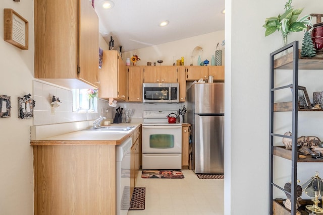 kitchen featuring tasteful backsplash, sink, stainless steel appliances, and lofted ceiling