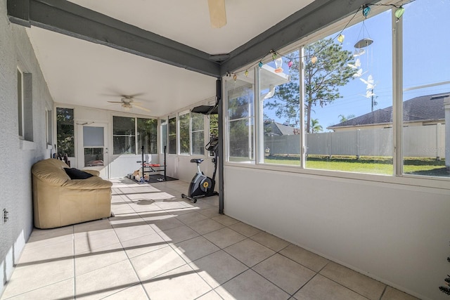 unfurnished sunroom with ceiling fan