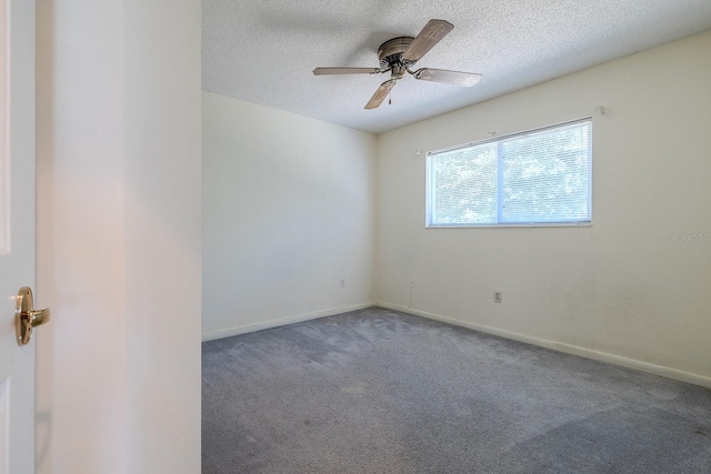 carpeted spare room featuring ceiling fan and a textured ceiling