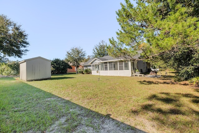 view of yard featuring a sunroom and a storage unit