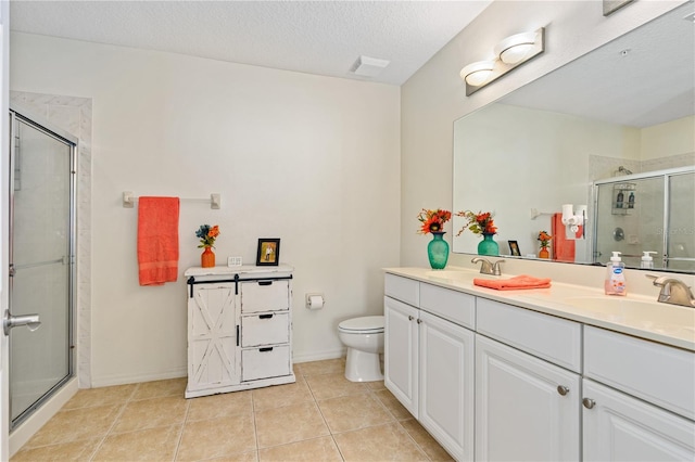 bathroom with vanity, tile patterned flooring, toilet, a textured ceiling, and an enclosed shower