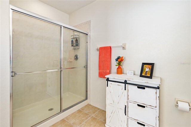 bathroom with tile patterned flooring and an enclosed shower