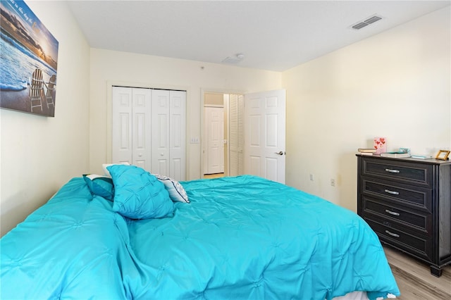 bedroom featuring light hardwood / wood-style flooring and a closet