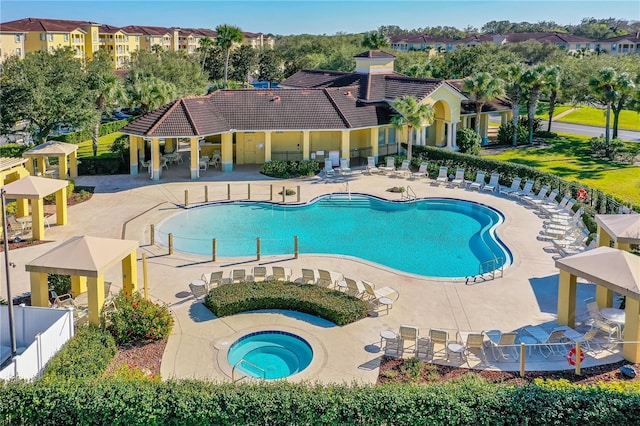 view of swimming pool with a gazebo, a community hot tub, and a patio