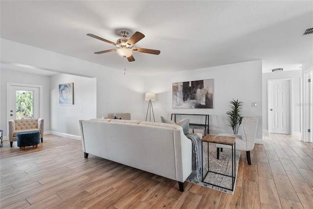 living room with ceiling fan and light hardwood / wood-style floors