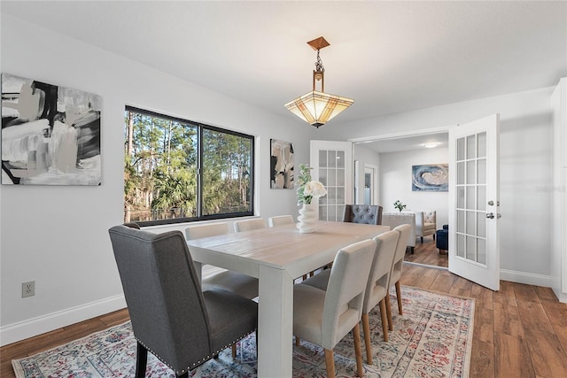 dining area featuring french doors and wood-type flooring