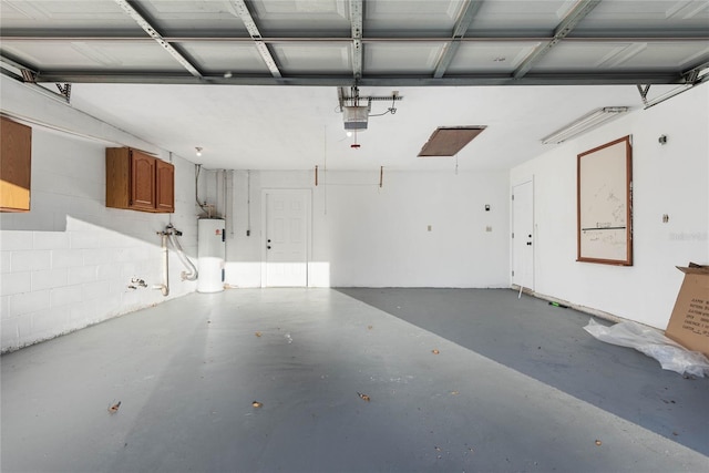 garage featuring a garage door opener and water heater