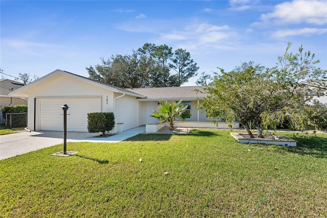 view of front of property with a front yard and a garage