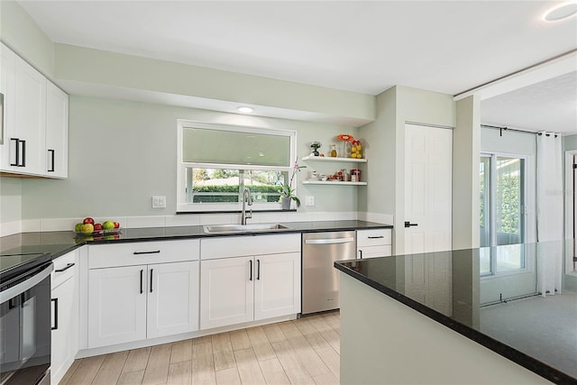 kitchen with white cabinets, dishwasher, electric stove, and sink