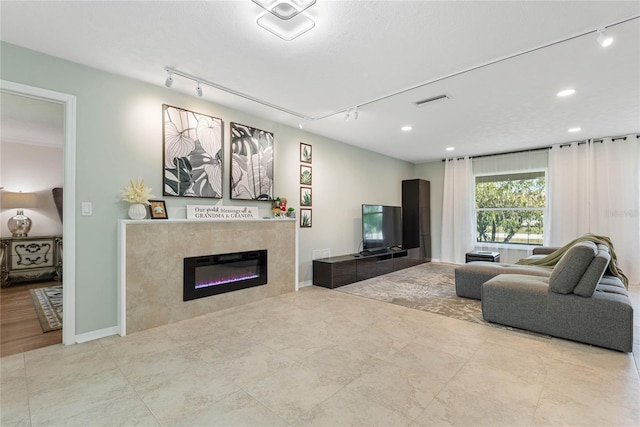 living room featuring a fireplace and track lighting