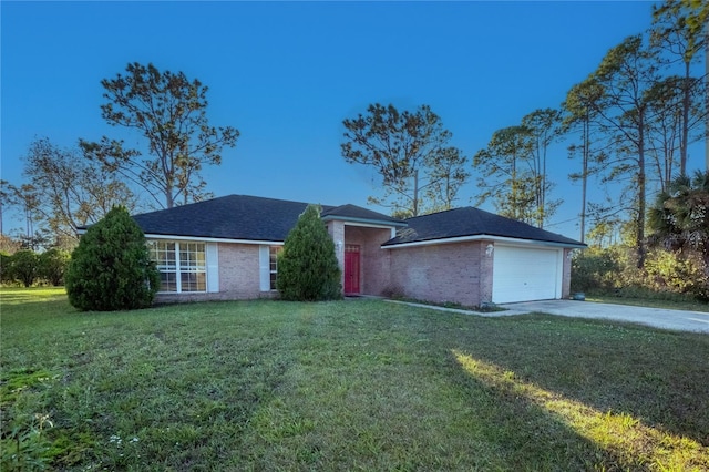 single story home featuring a garage and a front yard