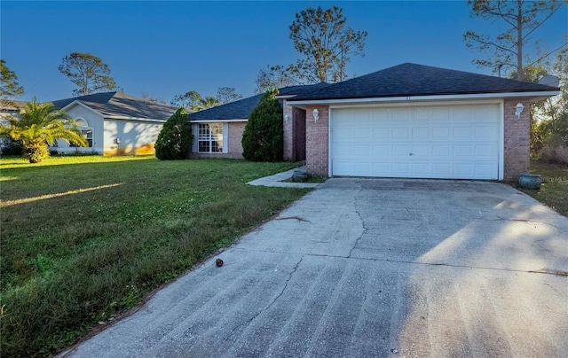 ranch-style home with a garage and a front lawn