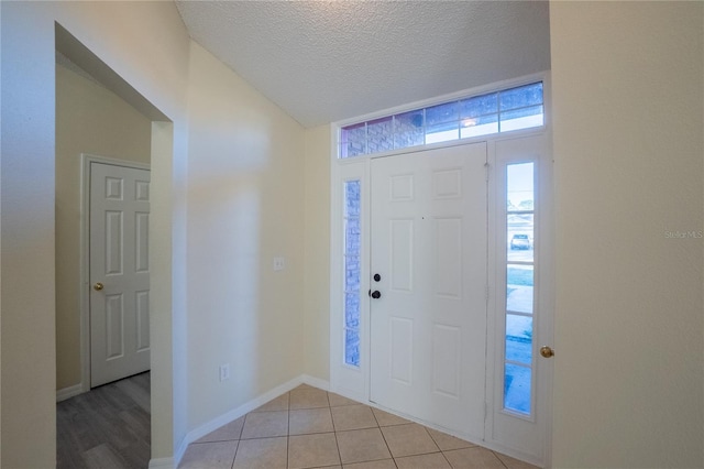 tiled entrance foyer featuring a textured ceiling