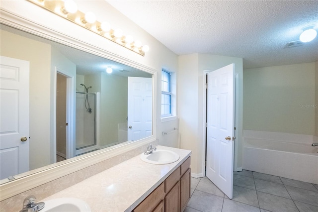 bathroom with tile patterned flooring, vanity, independent shower and bath, and a textured ceiling