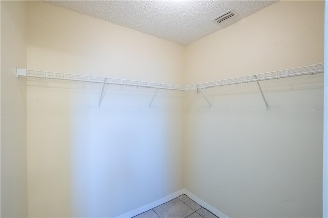 spacious closet featuring tile patterned floors