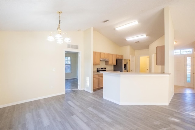 kitchen with light brown cabinets, stainless steel appliances, pendant lighting, a chandelier, and light wood-type flooring