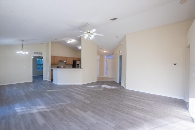 unfurnished living room featuring ceiling fan with notable chandelier, wood-type flooring, and high vaulted ceiling