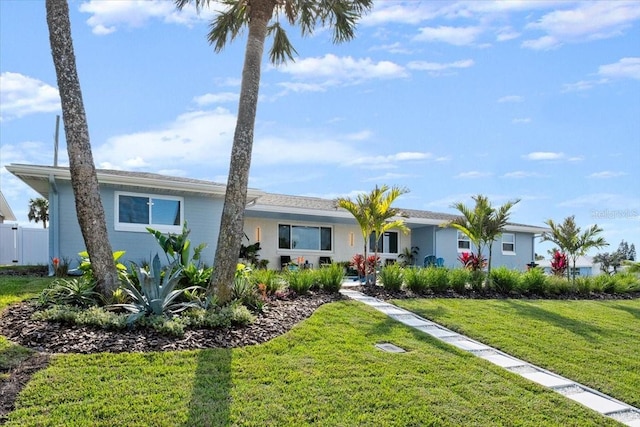 ranch-style home featuring a front yard