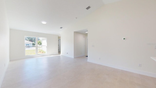 unfurnished room featuring lofted ceiling