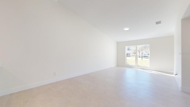 unfurnished room featuring vaulted ceiling