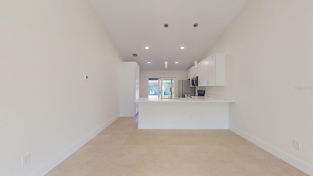 kitchen featuring kitchen peninsula, appliances with stainless steel finishes, sink, pendant lighting, and white cabinets