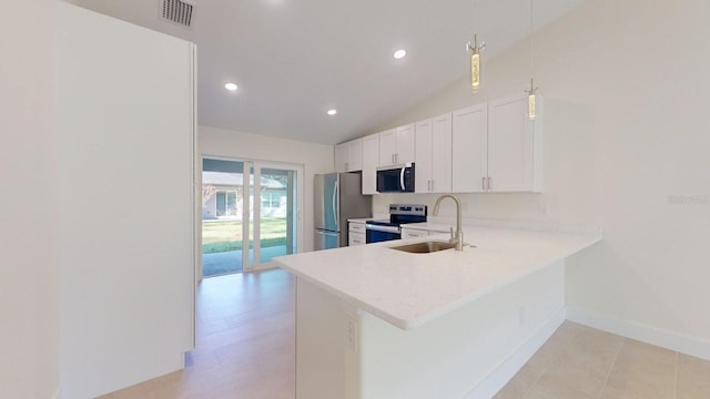 kitchen featuring sink, kitchen peninsula, vaulted ceiling, white cabinetry, and stainless steel appliances