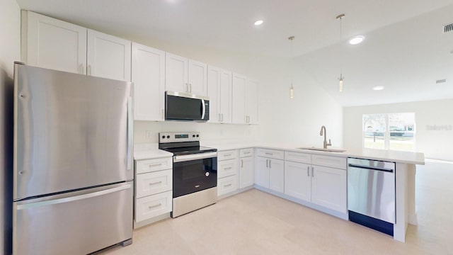 kitchen with pendant lighting, white cabinets, sink, kitchen peninsula, and stainless steel appliances