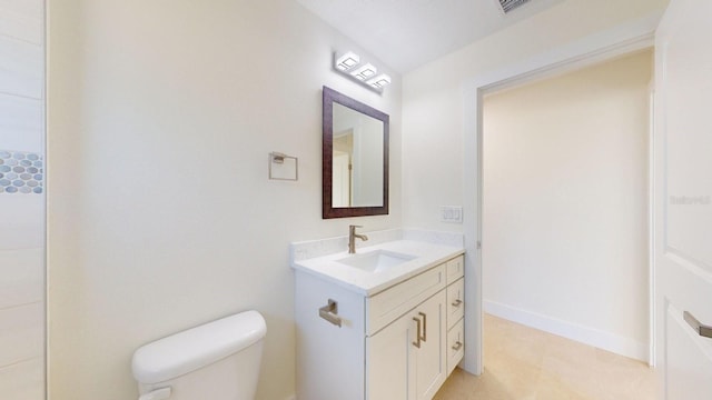 bathroom featuring tile patterned floors, vanity, and toilet