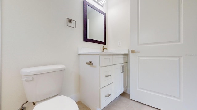 bathroom featuring tile patterned flooring, vanity, and toilet