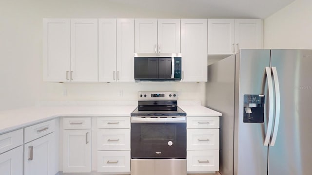 kitchen featuring stainless steel appliances and white cabinetry