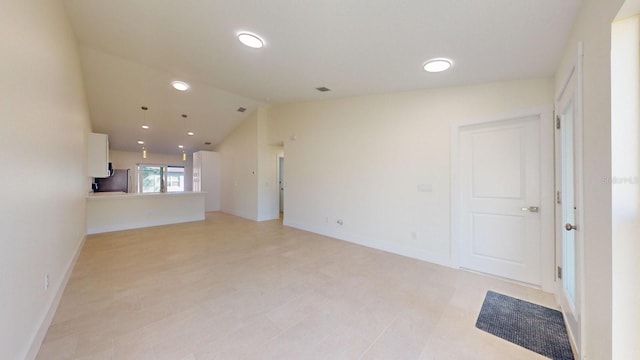 spare room featuring vaulted ceiling