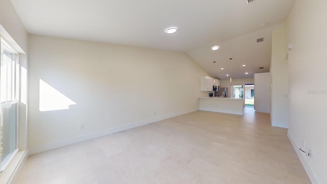 unfurnished living room with lofted ceiling