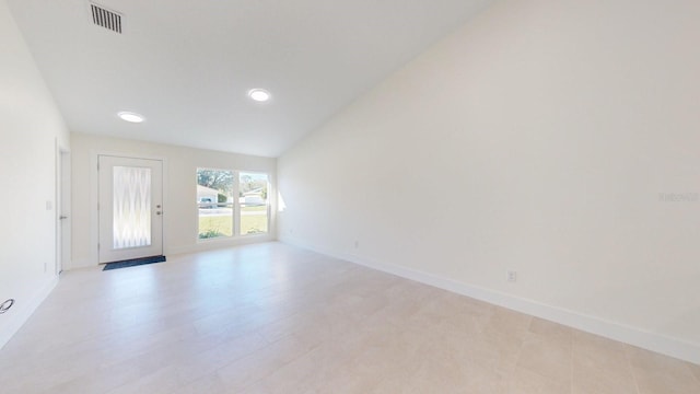 unfurnished room featuring light wood-type flooring and vaulted ceiling