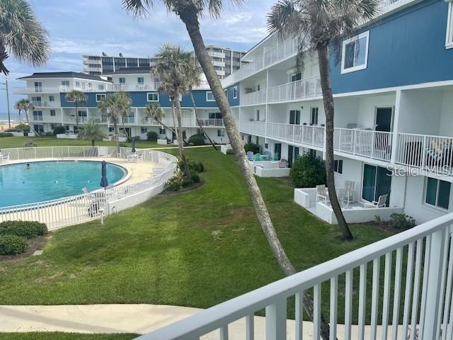 view of pool featuring a yard