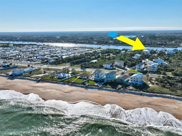 drone / aerial view featuring a water view and a view of the beach