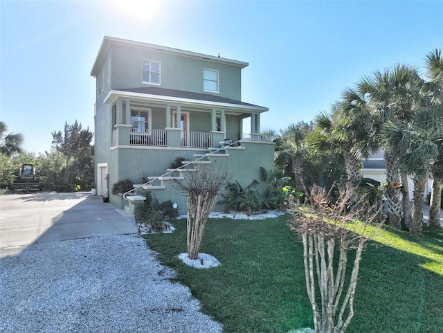 view of front of home with covered porch and a front lawn